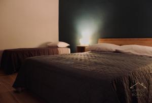 Postel nebo postele na pokoji v ubytování Antico Borgo Rooms