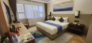 ein Hotelzimmer mit einem Bett und einem Fenster in der Unterkunft Ocean Delight Boutique Hotel 海悦精品酒店 in Sihanoukville