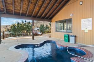 a swimming pool in front of a building at Seasons Four #172 Two bedroom plus loft in Snowmass Village