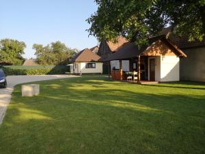 a house with a large lawn in front of it at Aterman Apartment's in Şinca Veche
