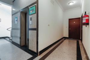 a hallway with two elevators in a building at Emara Grand Hotel in Bangalore