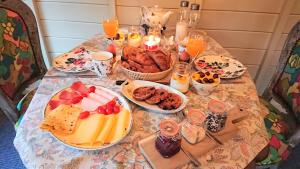 a table topped with plates of food and candles at Bed and Breakfast De Kleine Vos in Elspeet