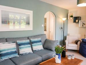 a living room with a couch and a table at Tor Cottage in Salcombe