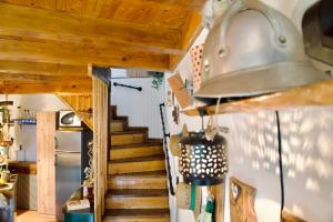 a room with a staircase with a bell on the wall at Stara hiža in Lanišće