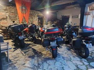 a row of motorcycles parked in a garage at Hotel Moto-Rural "VEGALION" in Las Salas