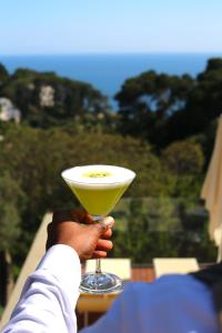a person holding a yellow drink in their hand at Hotel La Floridiana in Capri