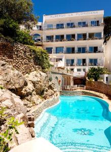 a swimming pool in front of a hotel at Hotel La Floridiana in Capri