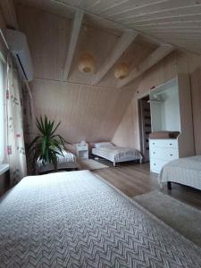 a bedroom with two beds and a dresser in a room at Arimaičių kaimo sodyba in Arimaičiai