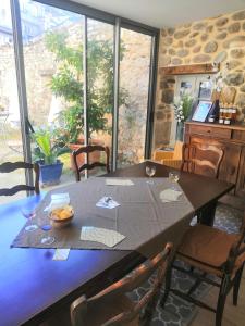 a dining room with a table with chairs and a tableablish at La Secrète in Vogüé +21 photos