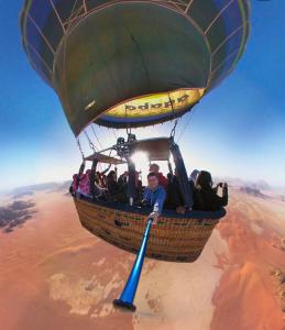 a group of people riding in a hot air balloon at Wadi rum camp in Wadi Rum