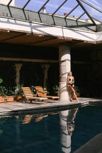 a woman in a bikini standing next to a swimming pool at Heybe Hotel & Spa in Göreme