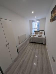 a bedroom with a bed and a large window at Bold street apartment in Liverpool