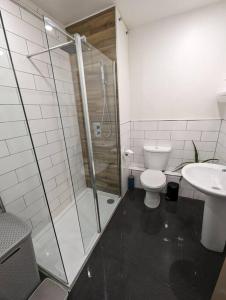 a bathroom with a shower and a toilet and a sink at Bold street apartment in Liverpool