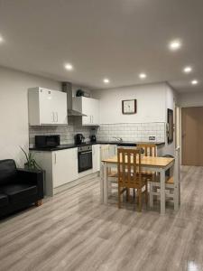 a kitchen and dining room with a table and chairs at Bold street apartment in Liverpool