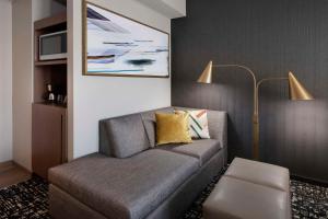 a living room with a couch and a lamp at Hyatt House LAX Century Blvs in Los Angeles