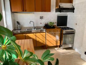 a kitchen with a sink and a stove at Appartamento indipendente a Mirafiori Sud in Turin