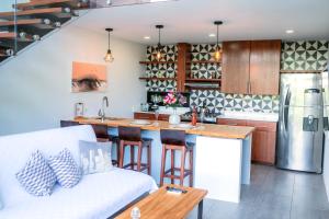 a kitchen and living room with a white couch at Tropical Loft Home - Ocean View in San Juan del Sur