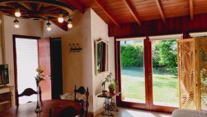 a living room with a table and large windows at Cabaña Monoambiente de Descanso y Relax en Zona Barrio La Florida Pet Friendly in Mar del Plata