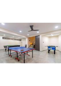 a room with two ping pong tables in it at Nemaan villa in Dhantoli