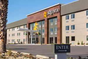 a hotel building with a sign in front of it at La Quinta Inn by Wyndham Columbia NE Fort Jackson in Columbia