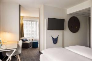 Ein Bett oder Betten in einem Zimmer der Unterkunft Vienna House Easy by Wyndham Berlin Prenzlauer Berg