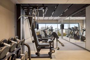 a gym with cardio equipment in a building at Vienna House by Wyndham Mokotow Warsaw in Warsaw