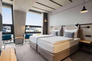 Cama ou camas em um quarto em Vienna House by Wyndham Mokotow Warsaw mais 37 fotos