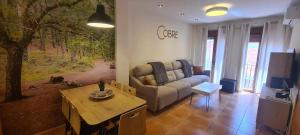 a living room with a couch and a table at Apartamento Cobre in Riópar