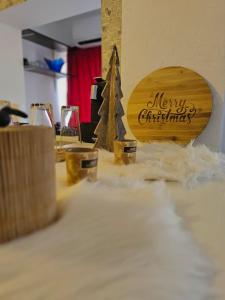 a wooden sign with a christmas tree on a table at Anastasia Crib in Craiova