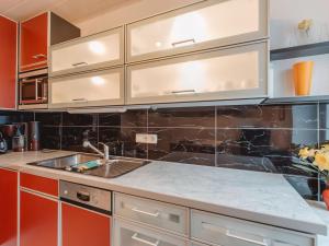 a kitchen with white cabinets and a sink at Apartment The Alpine Classic by Interhome in Badbruck
