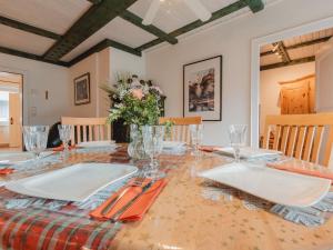 a dining room with a table with plates and napkins at Apartment The Alpine Classic by Interhome in Badbruck