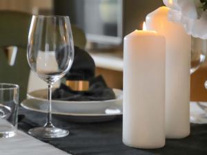 a candle and a wine glass on a table at Apartment Allod Park Haus C 704 by Interhome in Davos +38 photos