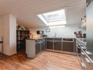 a kitchen with gray cabinets and a skylight at Apartment Rudis Appartements-4 by Interhome in Badbruck