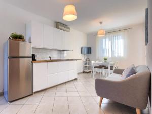 a kitchen and living room with a couch and a refrigerator at Apartment Fiore-2 by Interhome in Gedići +23 photos