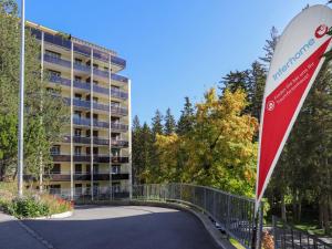 a bridge over a road in front of a building at Apartment Allod-Park-7 by Interhome in Davos