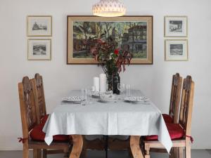 a dining room table with a vase of flowers on it at Apartment Allod-Park-47 by Interhome in Davos