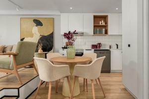 a kitchen and dining room with a table and chairs at Suro Luxury Apartments in Cape Town