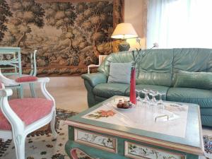 a living room with a couch and a table at Holiday Home Les Rimains by Interhome in Cancale