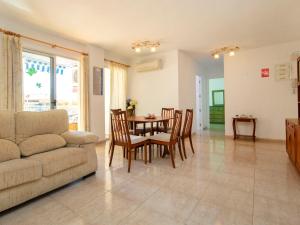 a living room with a couch and a table and chairs at Apartment Apolo IV-8 by Interhome in Calpe +18 photos