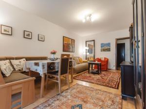 a living room with a couch and a table at Apartment FeWo Sun & Snow by Interhome in Bad Hofgastein +27 photos