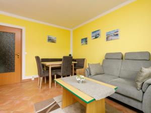 a living room with a couch and a table at Apartment Dünenhaus App- 104 by Interhome in Zempin