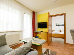 a living room with a couch and a table at Apartment Dünenhaus App- 104 by Interhome in Zempin +15 photos