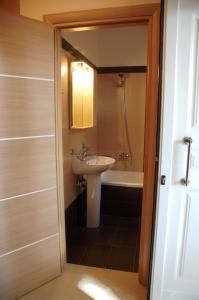 a bathroom with a sink and a bath tub at Zeis Edo Luxury Apartments in Tolo