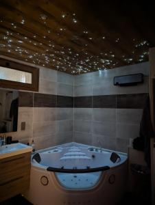 a bath tub in a bathroom with two sinks at Les Myrtilles, appartement au pied des pistes in Saint-Pierre-dels-Forcats
