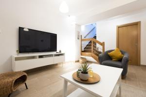 a living room with a flat screen tv on a wall at ARROLA by Smiling Rentals in Hondarribia