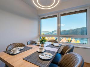 a dining room with a table and chairs and a large window at Apartment Seensucht alpe maritima Ski & See-Top 25 by Interhome in Annenheim