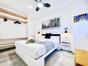 a white bedroom with a large bed and a ceiling at Charming Madrid Principe Pio in Madrid