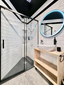 a bathroom with a sink and a mirror at Charming Madrid Principe Pio in Madrid