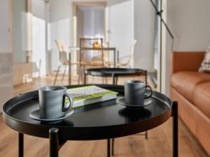 two coffee mugs on a table in a living room at Apartment Černý Důl-3 by Interhome in Černý Dŭl +45 photos
