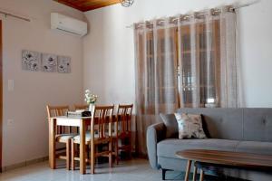 a living room with a couch and a table at Villa Magda in Syvota